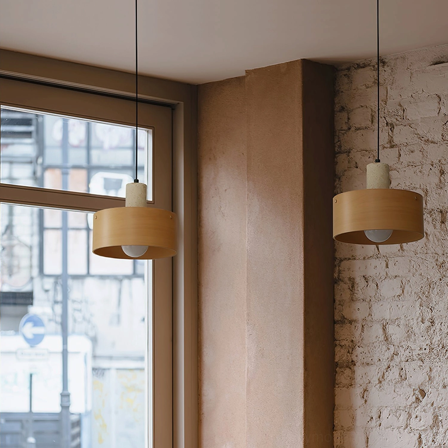 Multiple Tako pendant lamps with warm wood tones in urban apartment living area with exposed brick