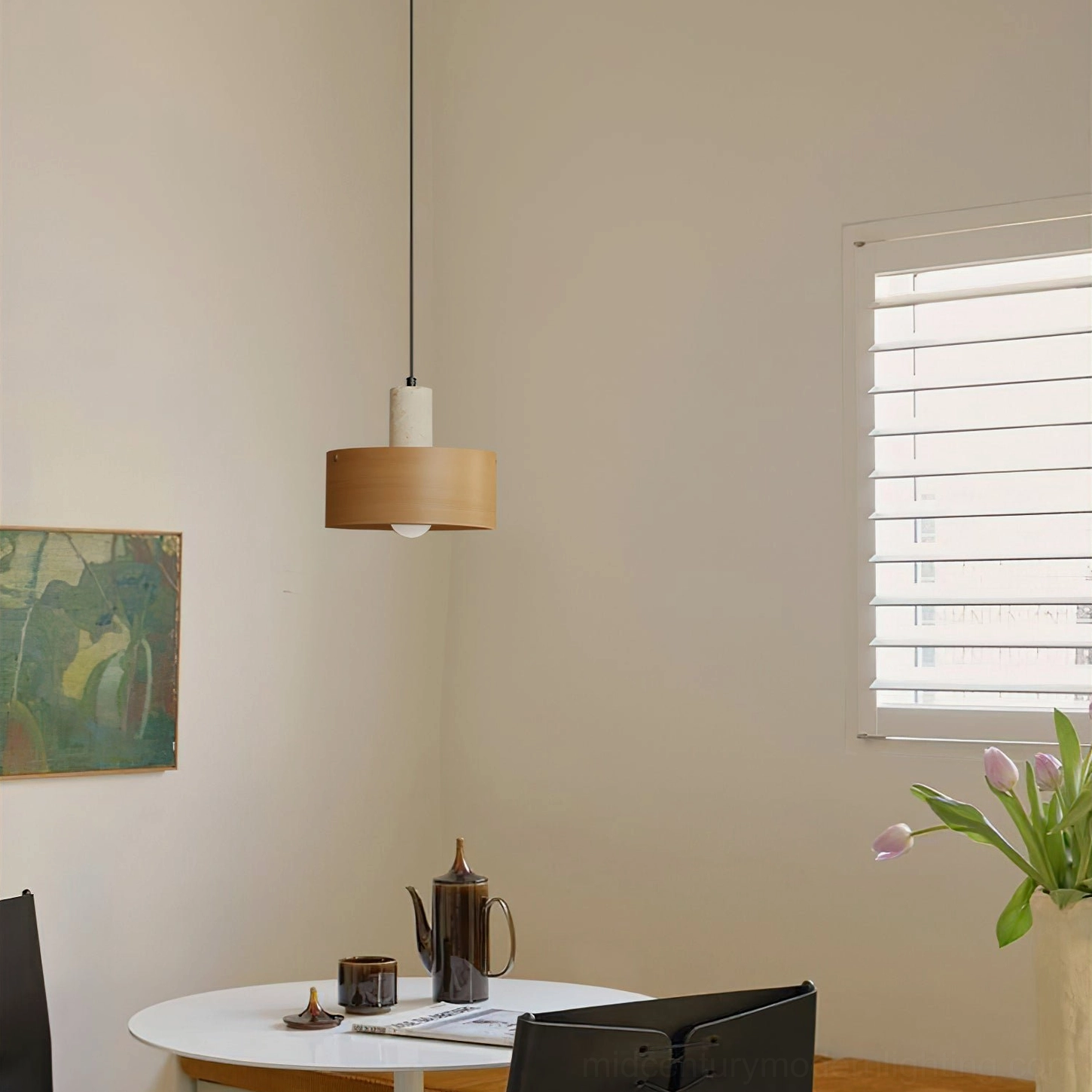Light wood Tako pendant lamp in small dining nook showing minimalist drum shade design