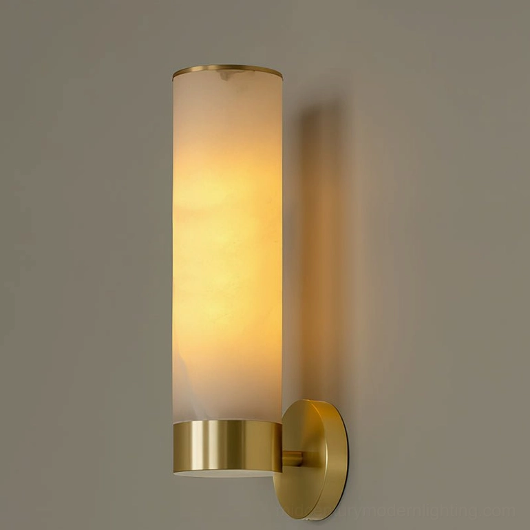 Tall alabaster cylinder wall sconce with brass lower hardware and natural stone shade, front flat lay on gray background
