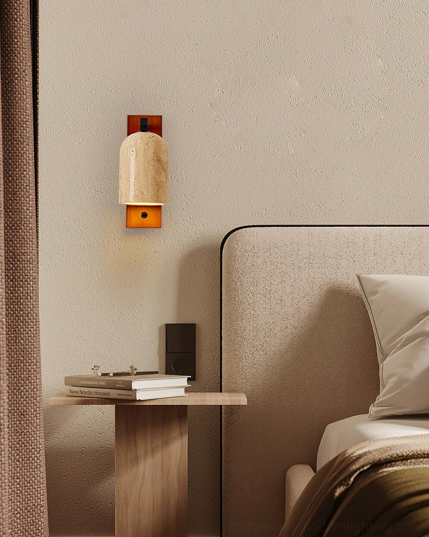 Tersus wall sconce illuminated above upholstered headboard showing warm stone glow