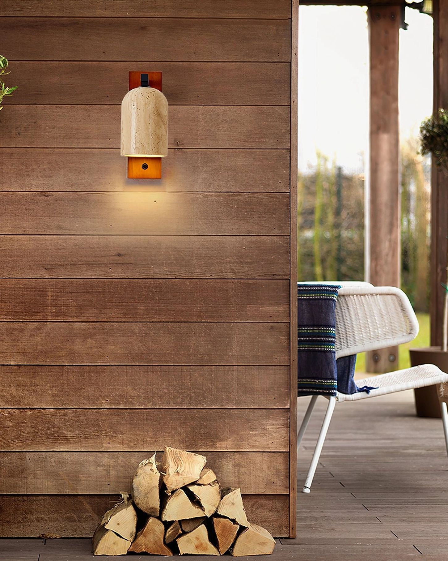 Tersus travertine wall sconce with warm Edison bulb creating atmospheric bedroom lighting