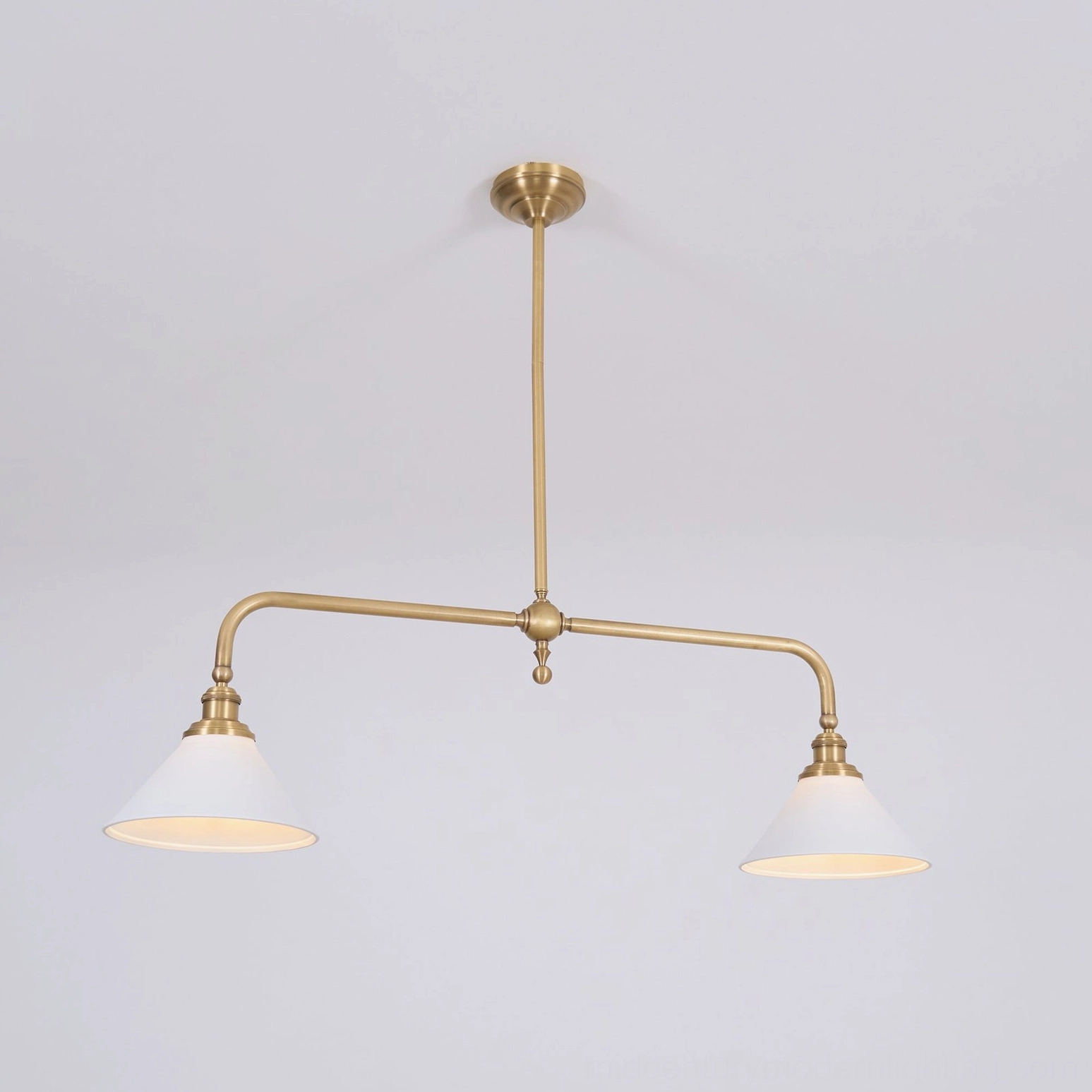 Theron mid-century modern brass chandelier detail shot showing brushed brass finish, welded joints, and white ceramic cone shade construction