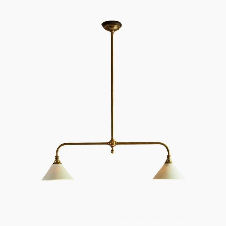 Curved-arm linear brass chandelier fixture in studio setting, antique brass finish with white cone lamp shades and extended central rod detail
