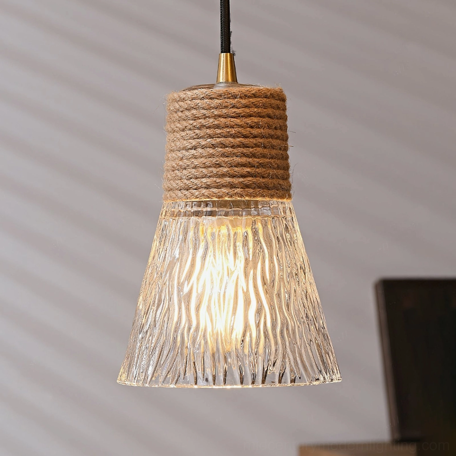 Three hemp rope glass pendant lamps arranged together, clustered installation for dramatic dining room lighting