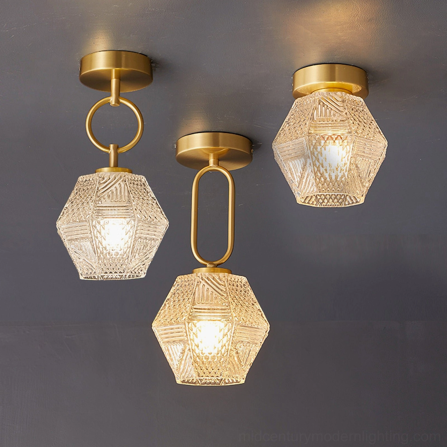 Set of three diamond cut Art Deco ceiling lights with brass finish and textured glass shades