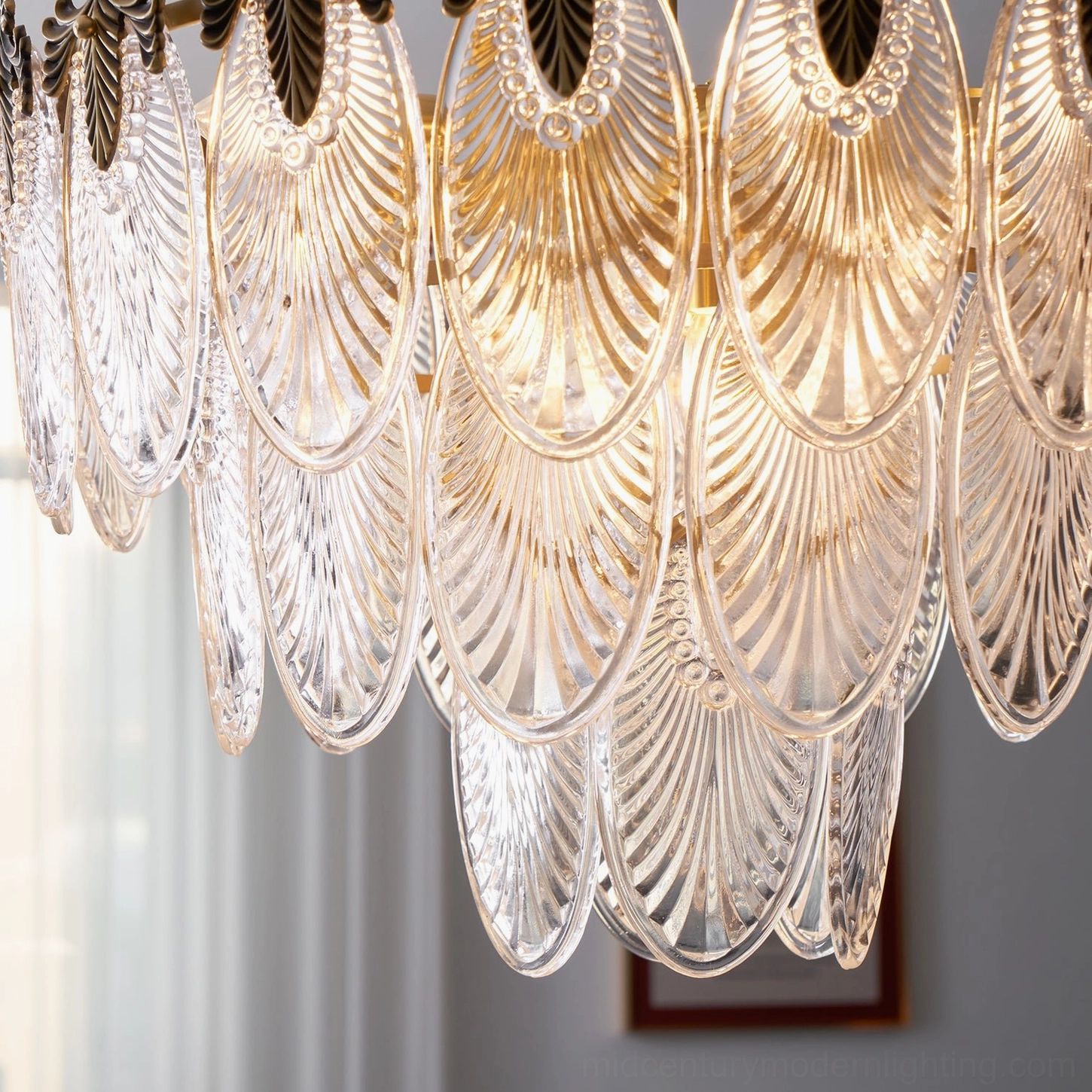 Art Nouveau brass leaves chandelier showing three descending tiers with ornamental acanthus crowns and carved glass leaf pendants