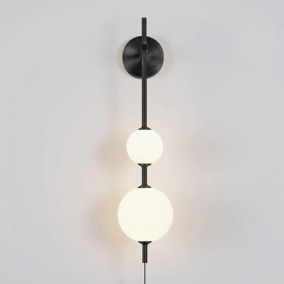 Three-tier vertical globe wall sconce in brass, sculptural mid-century modern design lighting