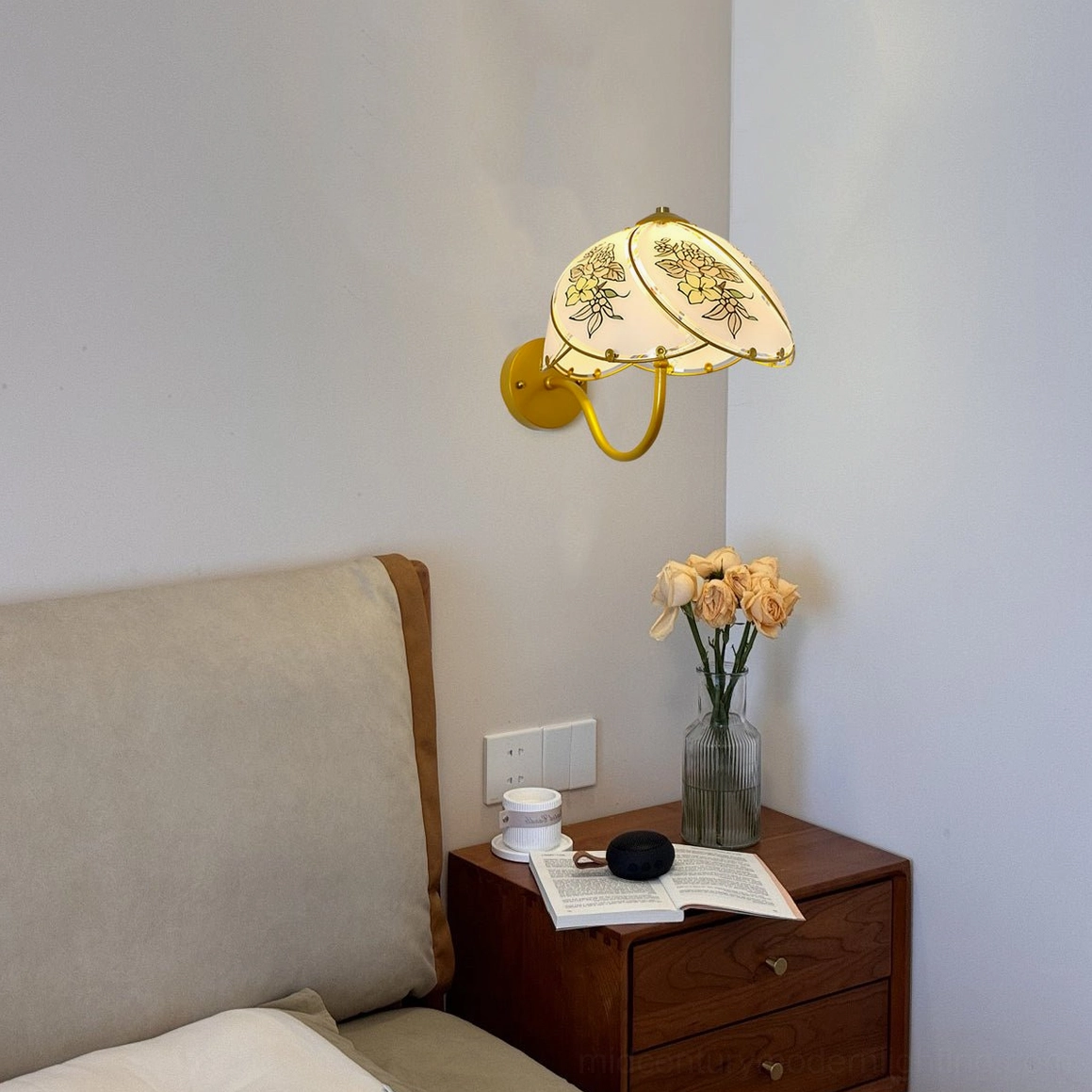 Tiffany Lily Wall Sconce positioned on bedroom bedside wall above wooden nightstand and floral arrangement