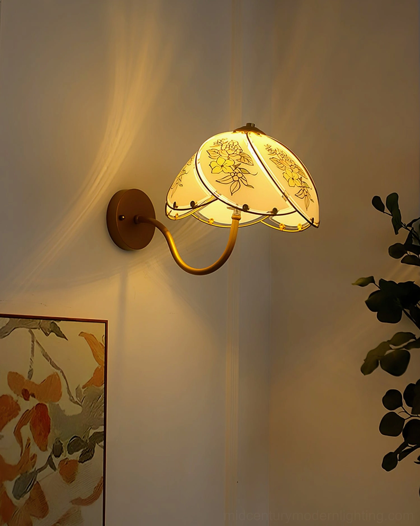 Tiffany Lily Wall Sconce creating warm textured lighting effect on residential wall with abstract art