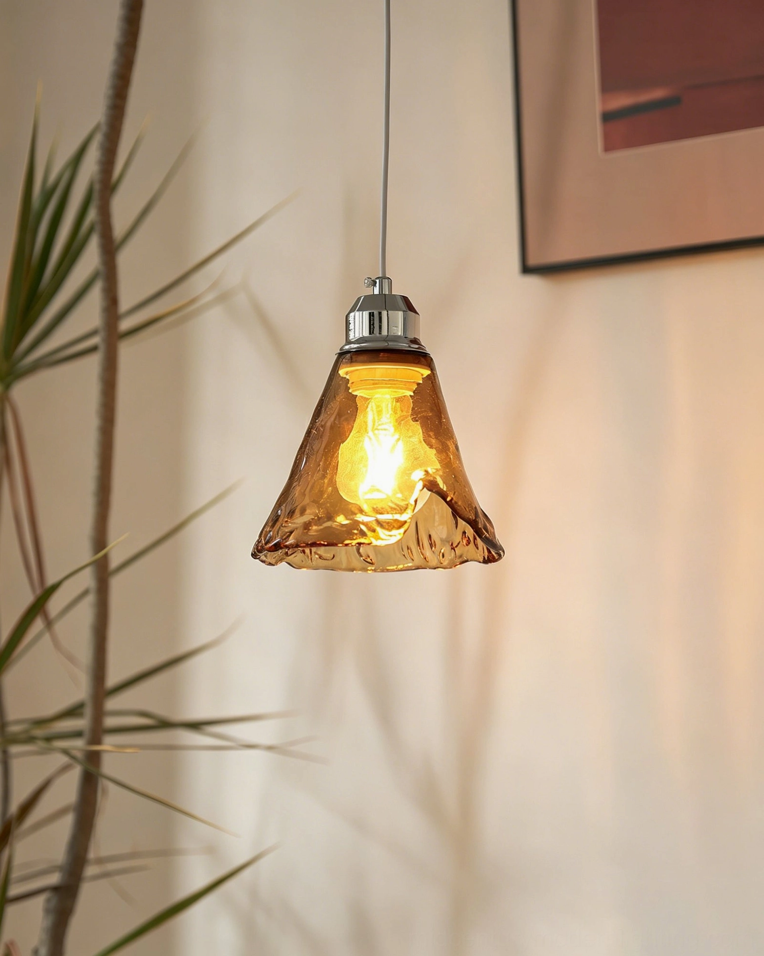 Tiro pendant light front three-quarter angle view showing conical amber glass shade with textured surface