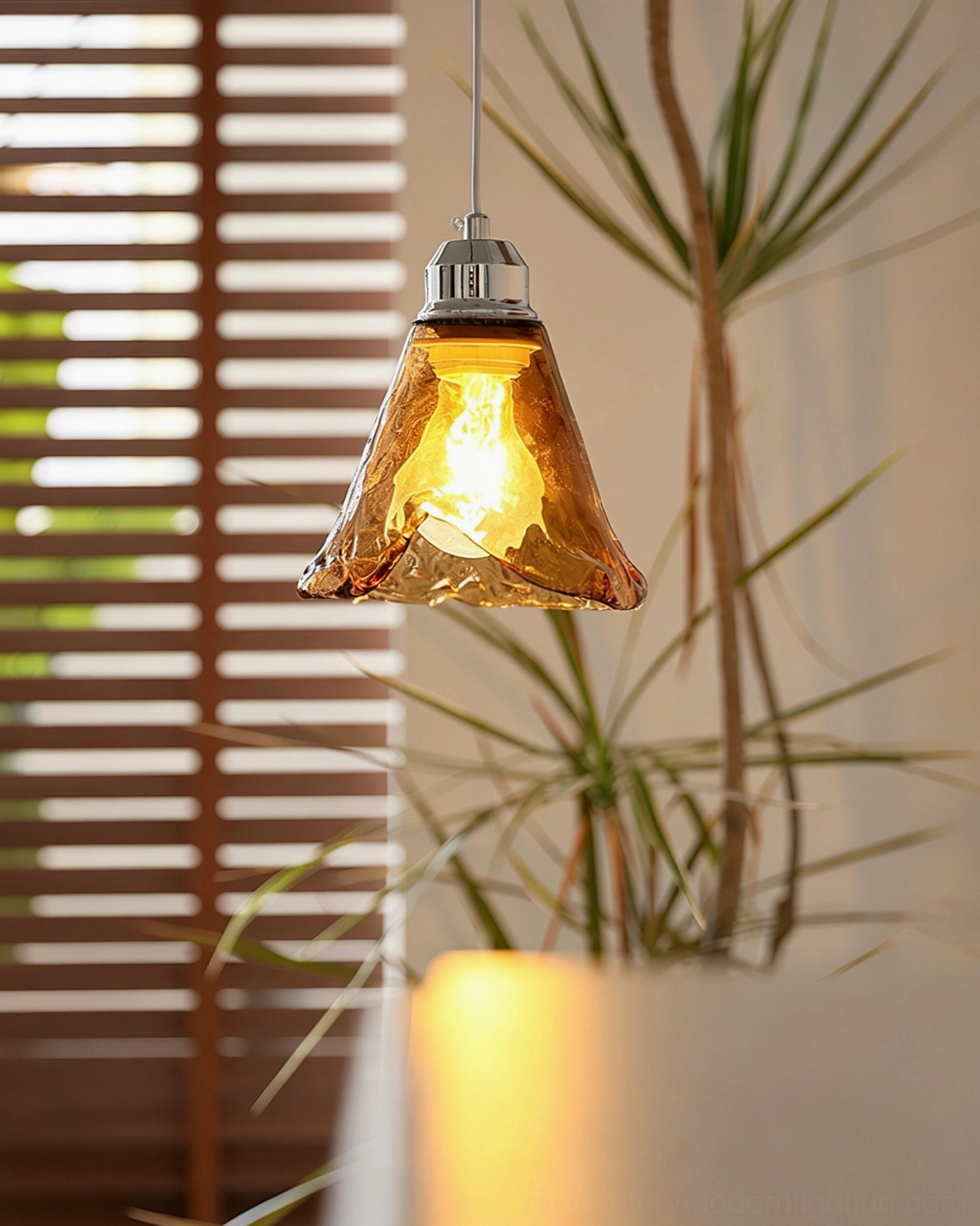 Tiro amber glass pendant collection showing consistent wavy design across multiple fixtures in indoor space