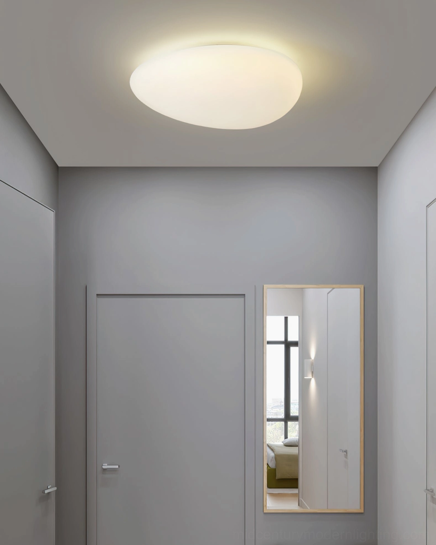 Toan LED fixture mounted flush in apartment corridor ceiling with door and mirror, demonstrating low-profile installation