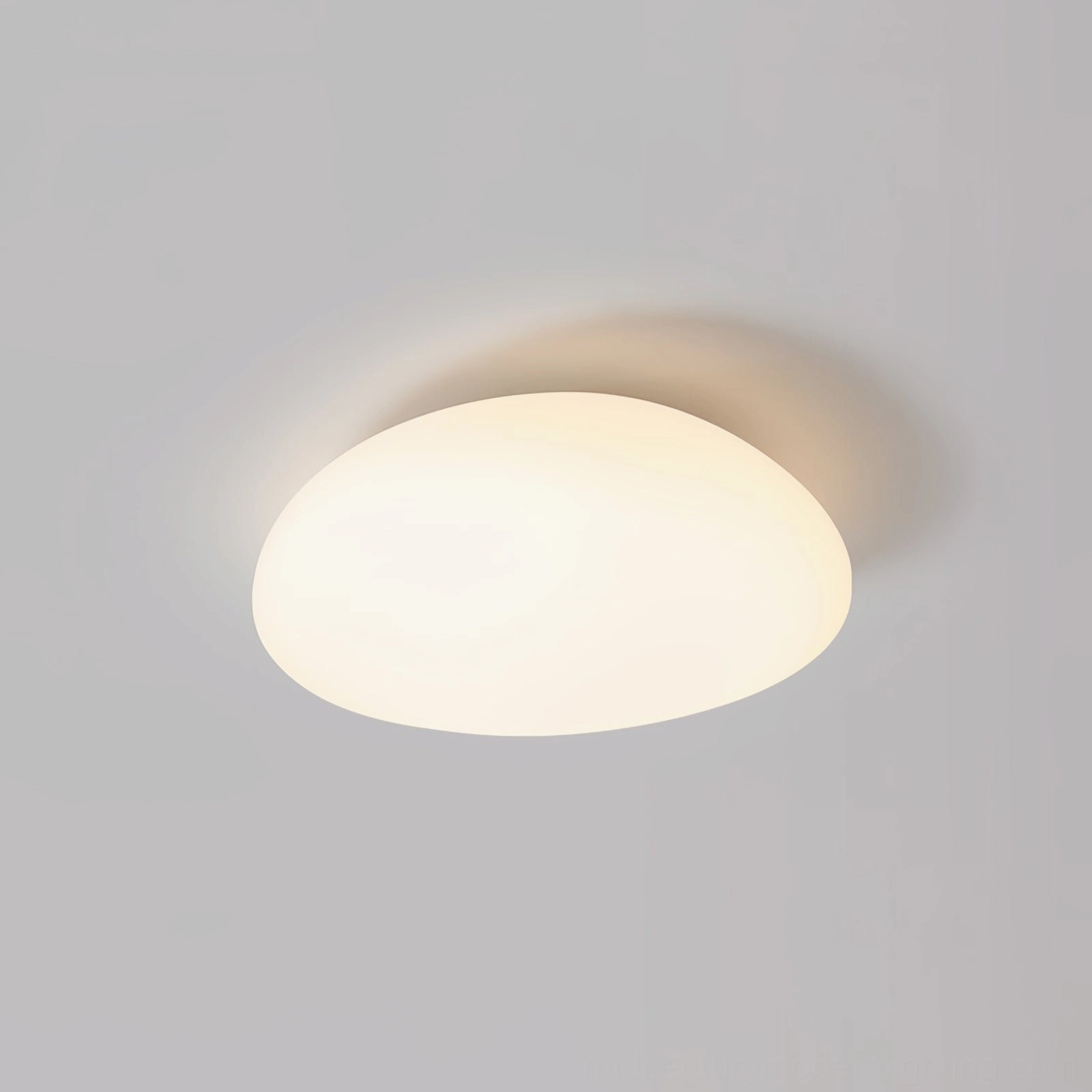 Illuminated Toan LED ceiling fixture showcasing soft warm white light diffusion through frosted PE dome