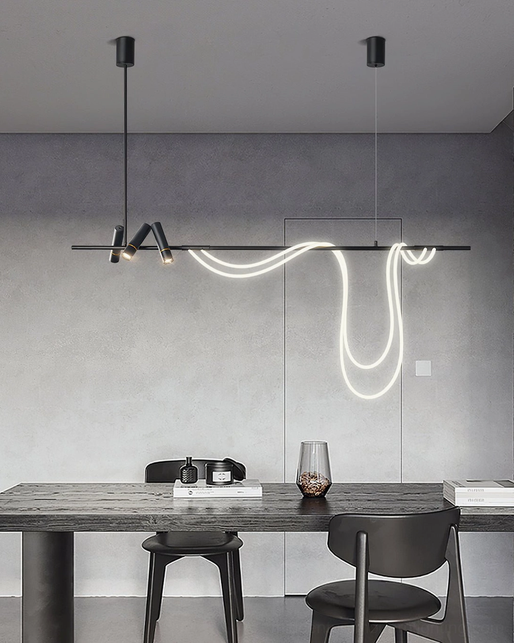 Contemporary linear pendant light in industrial concrete dining room with black chairs and warm neon glow