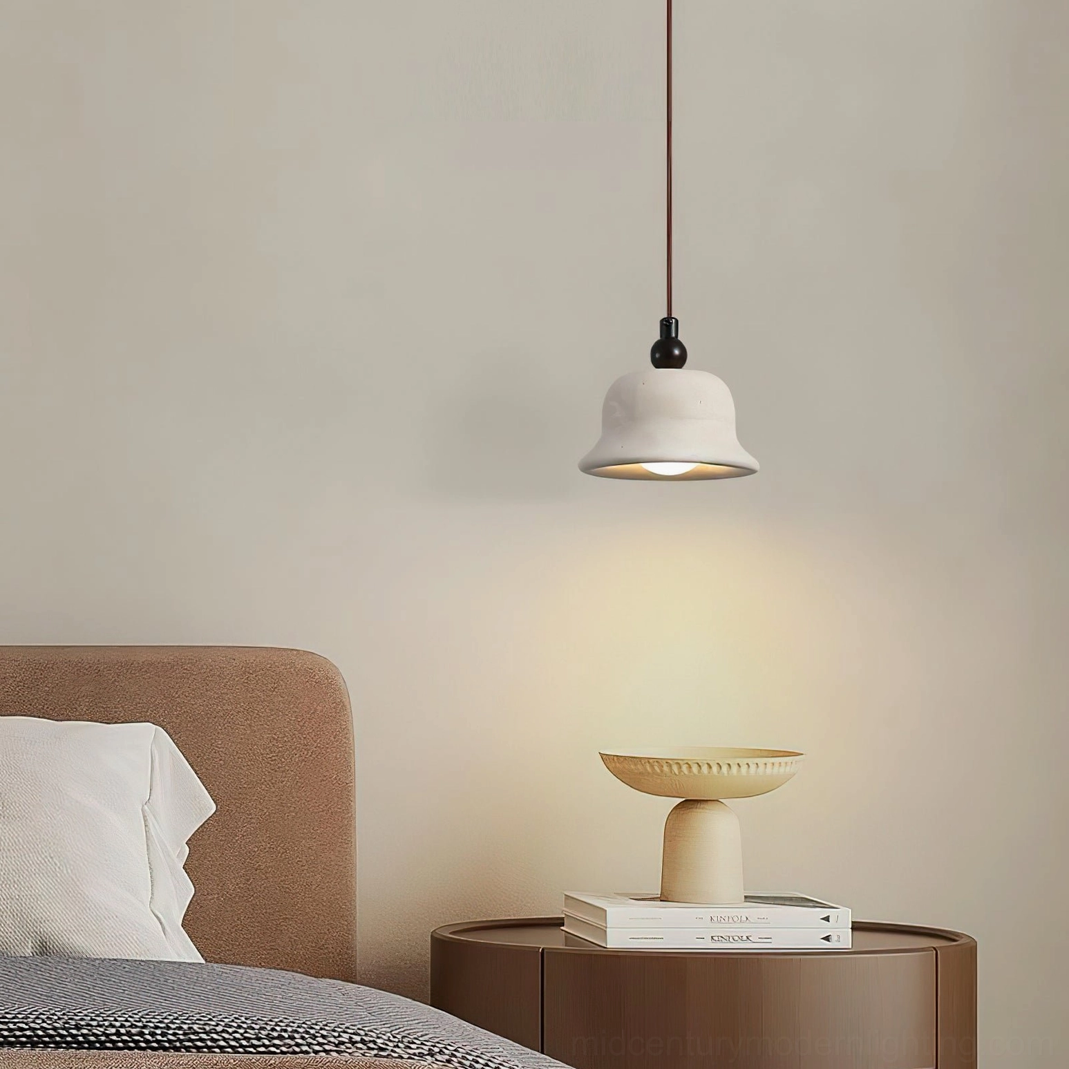 Single travertine pendant light above nightstand with soft warm illumination