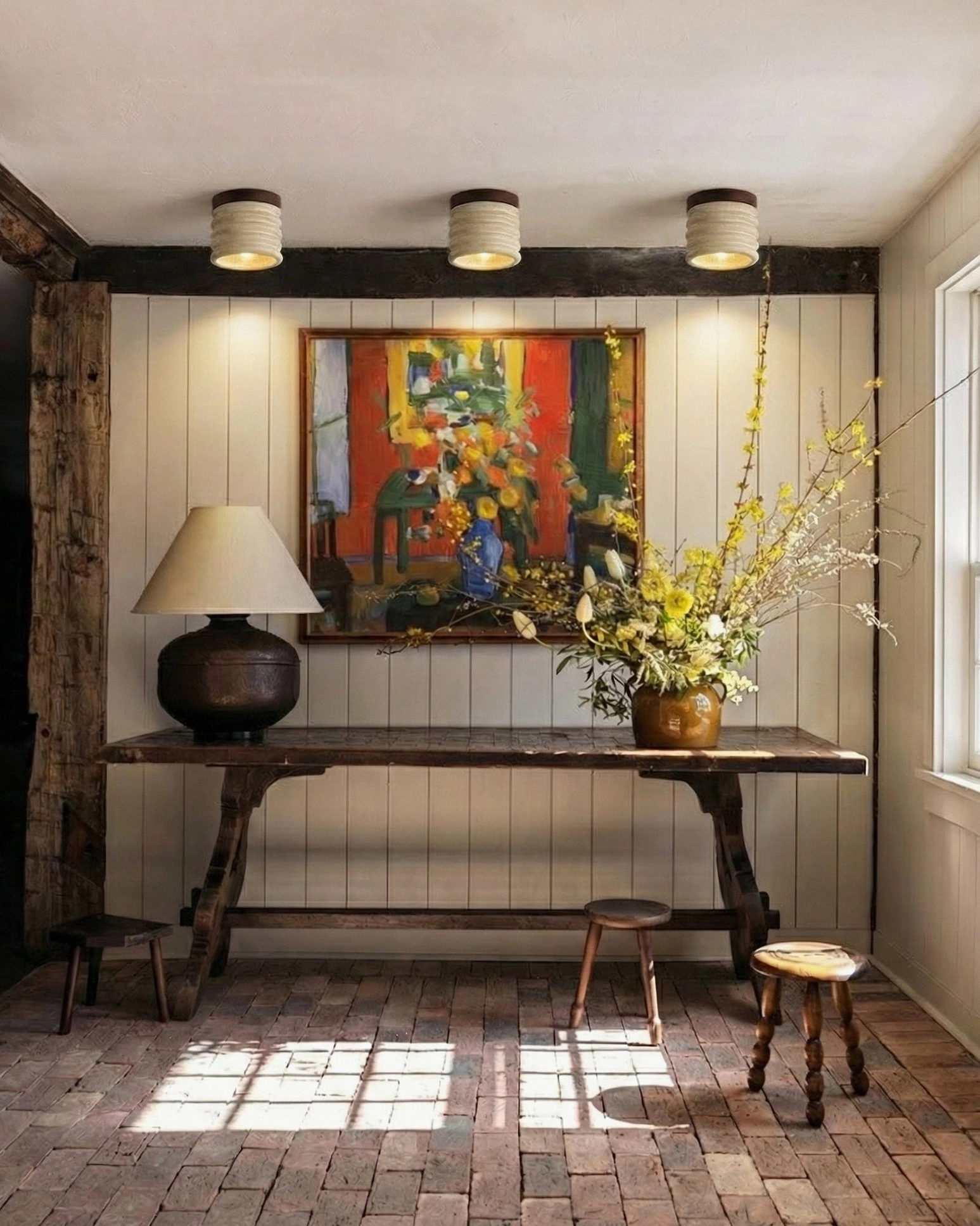 Trio of travertine ceiling lamps mounted in rustic residential dining room, bohemian warm interior