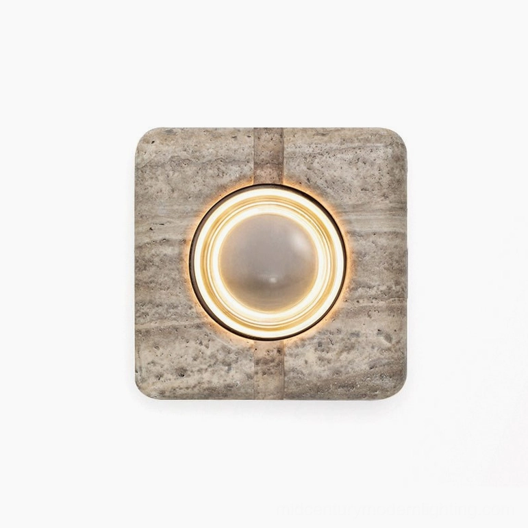 Travertine wall lamp with clear glass lens and warm white LED creating ambient light