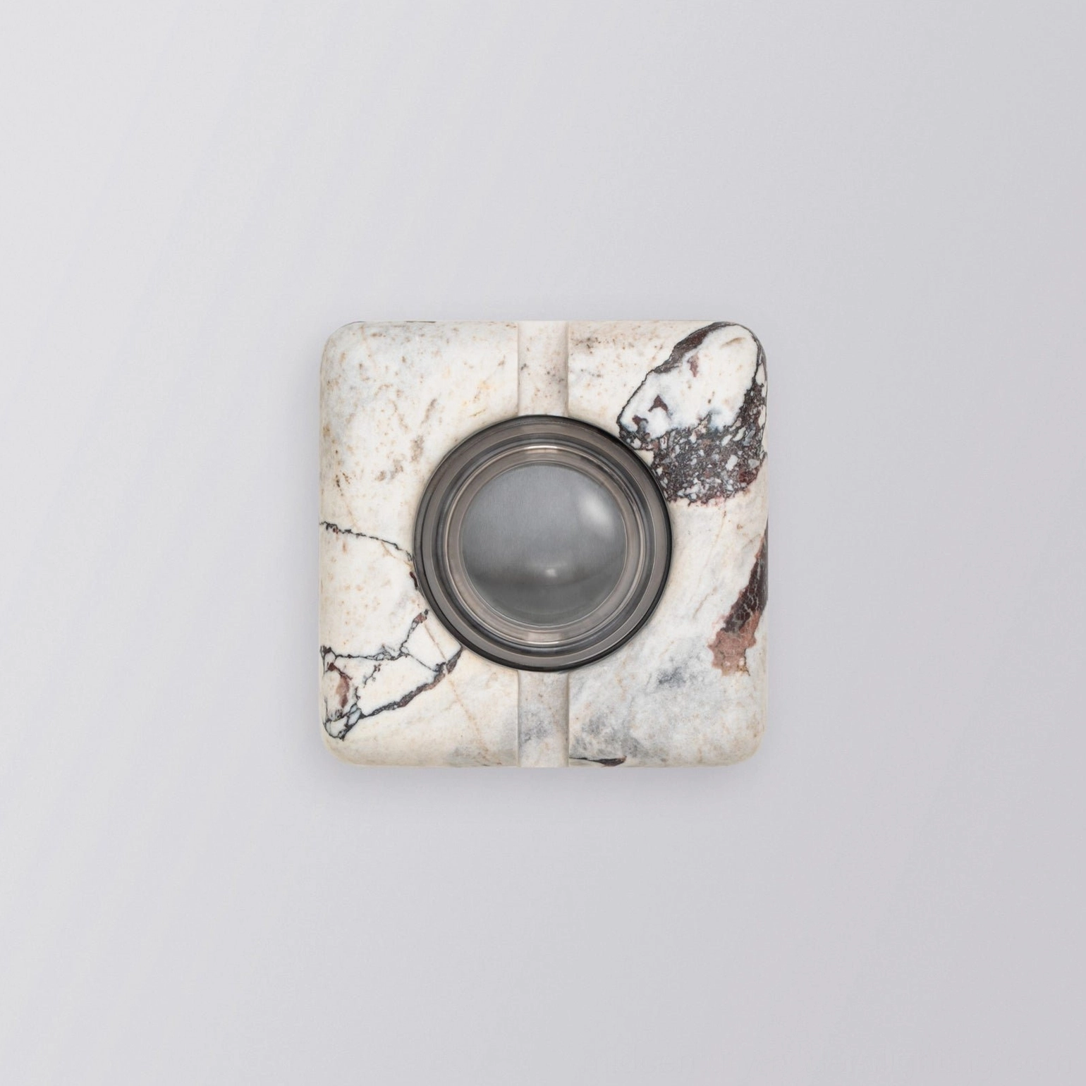 Rectilinear travertine wall lamp with clear glass diffuser showing interior lighting design