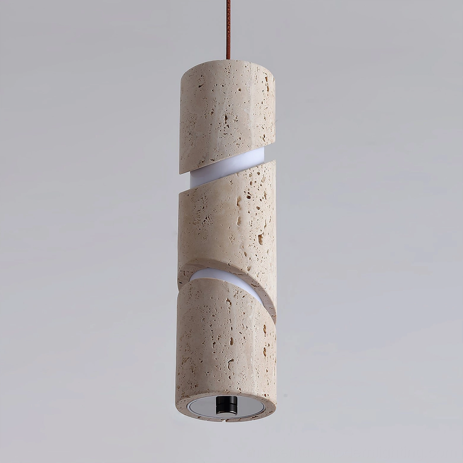 Close-up detail of travertine pendant lamp showing intricate spiral cutout pattern and natural stone pore texture