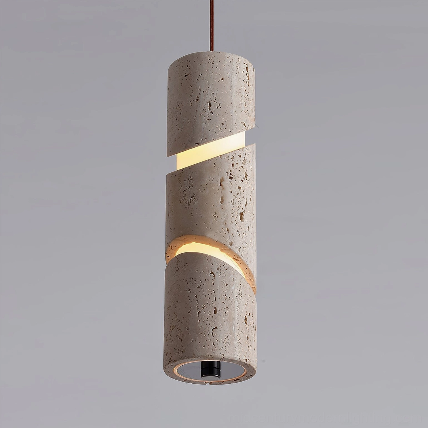 Close-up of travertine pendant lamp illuminated, highlighting spiral light openings and warm LED glow