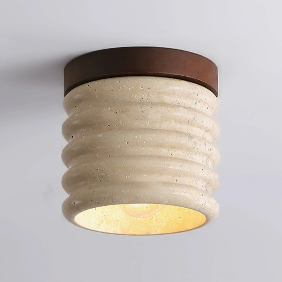 Close-up detail of travertine ceiling lamp showing ribbed surface texture and dark metal base with warm light glow