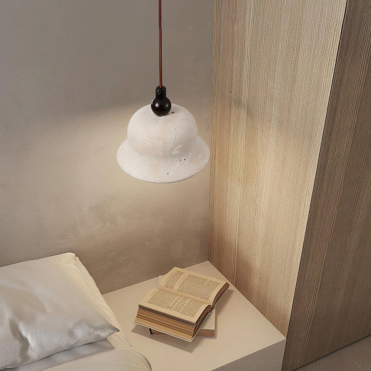 Textured travertine shade pendant lamp with brown cord in bedroom corner