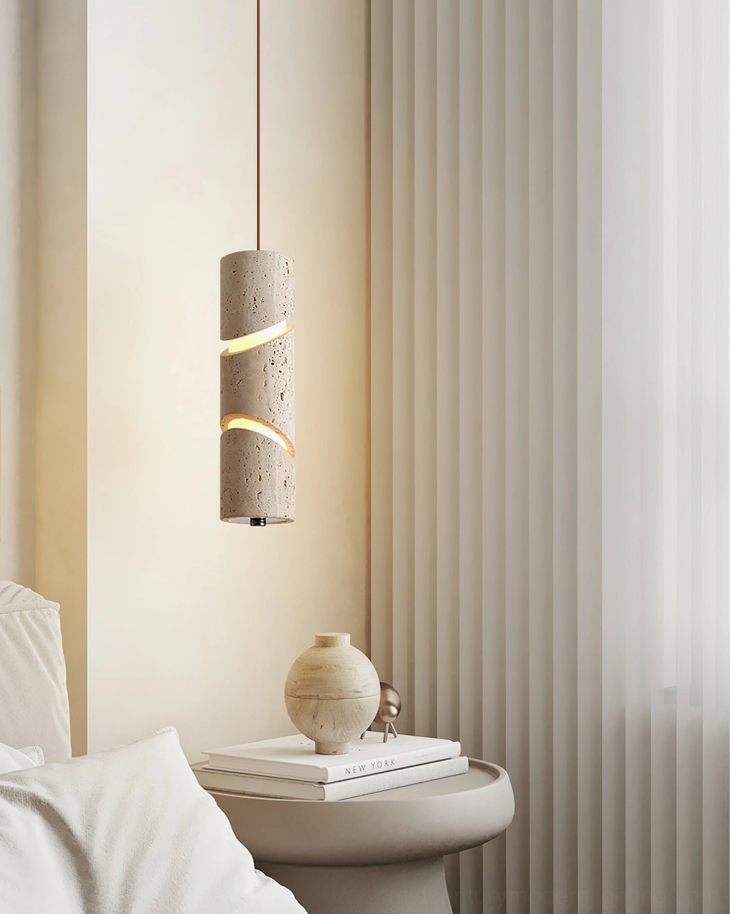 Travertine pendant lamp suspended above bed with sheer curtains, creating minimalist warm lighting atmosphere