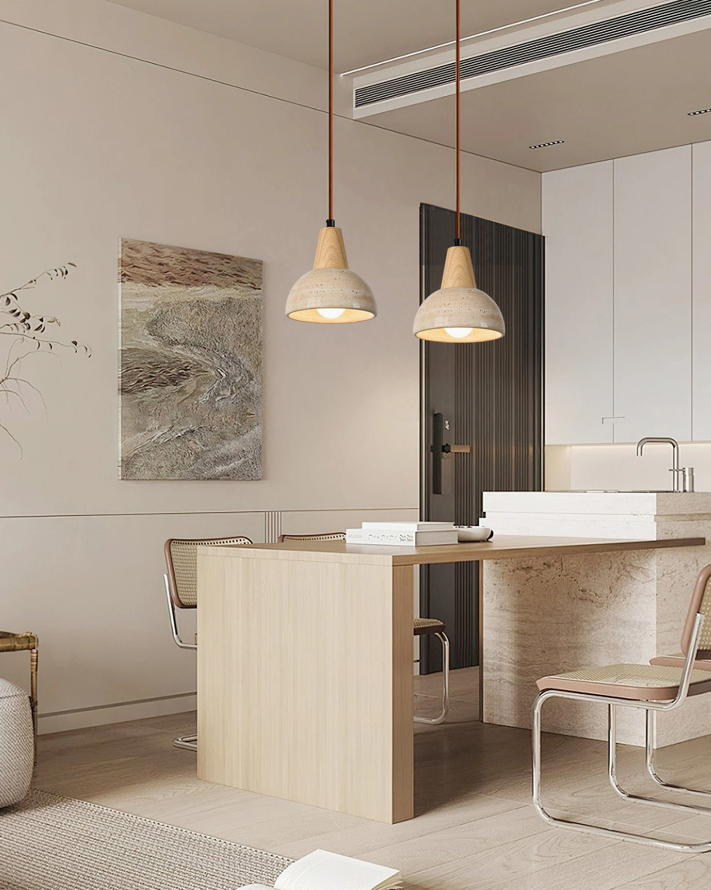 Dual travertine pendant lights in modern warm-toned kitchen with open layout and light wood cabinetry