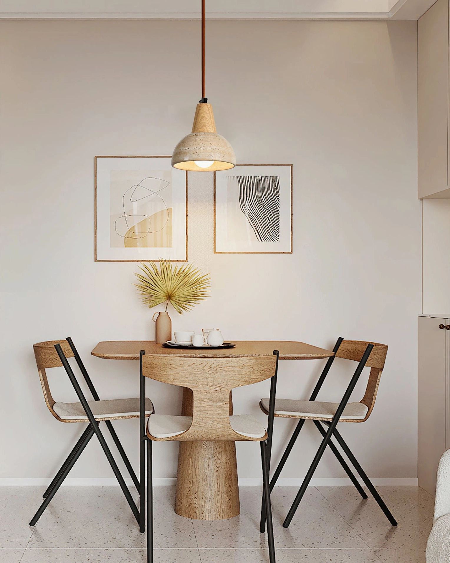 Single travertine pendant lamp in small dining nook with neutral minimalist interior and round wooden table
