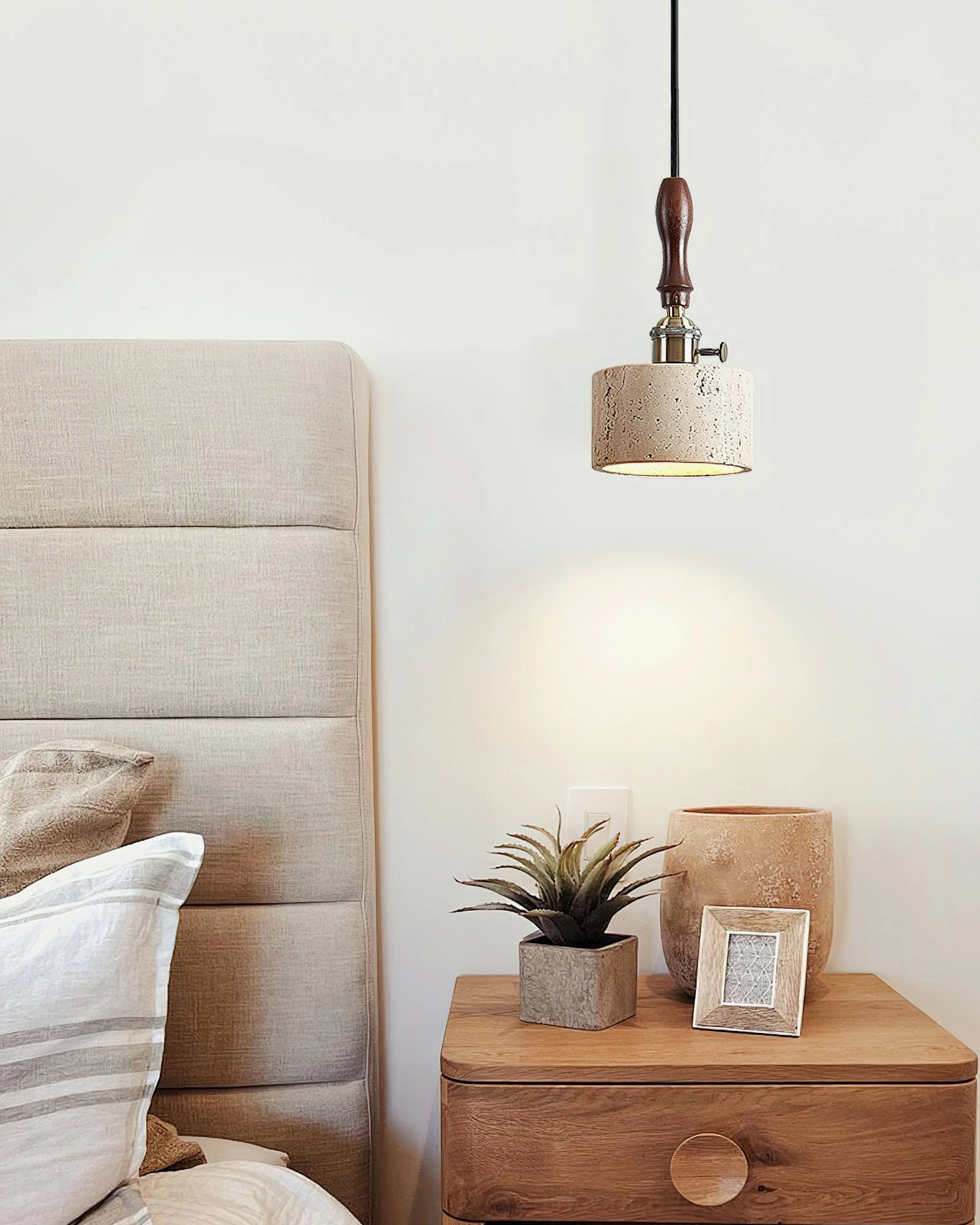 Travertine pendant light in bedroom with upholstered headboard fitting neutral rustic interior design