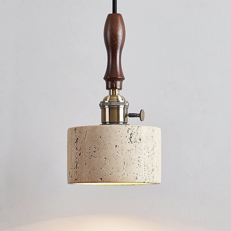 Travertine pendant light close-up showing brass hardware and walnut wood handle craftsmanship