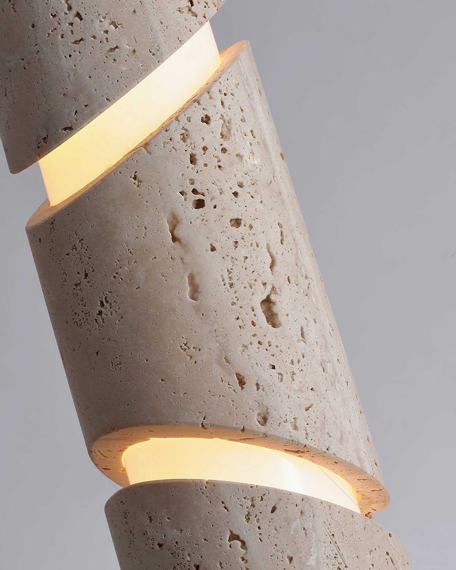 Travertine sculptural pendant lamp full product view showing cylindrical form, wood accents, and hanging cord