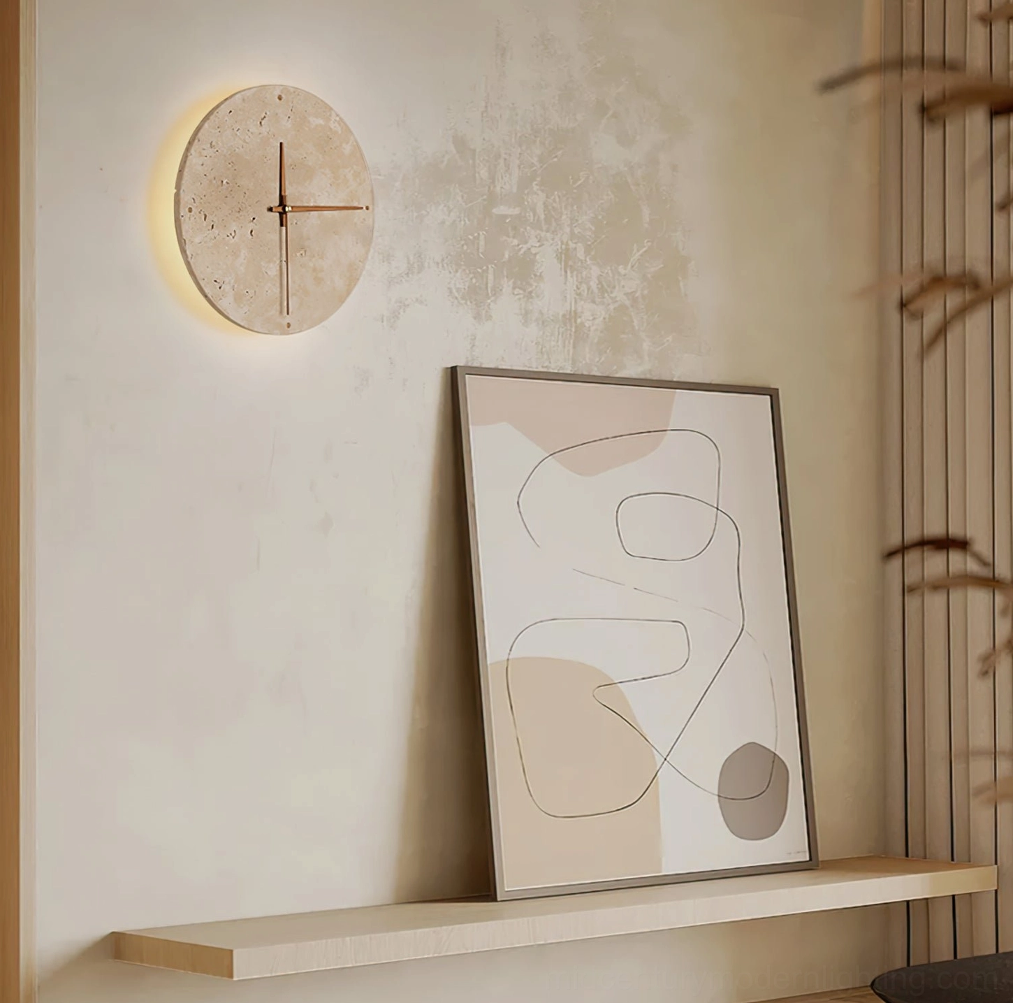 Travertine clock lamp on floating shelf with abstract wall art in neutral minimalist interior design
