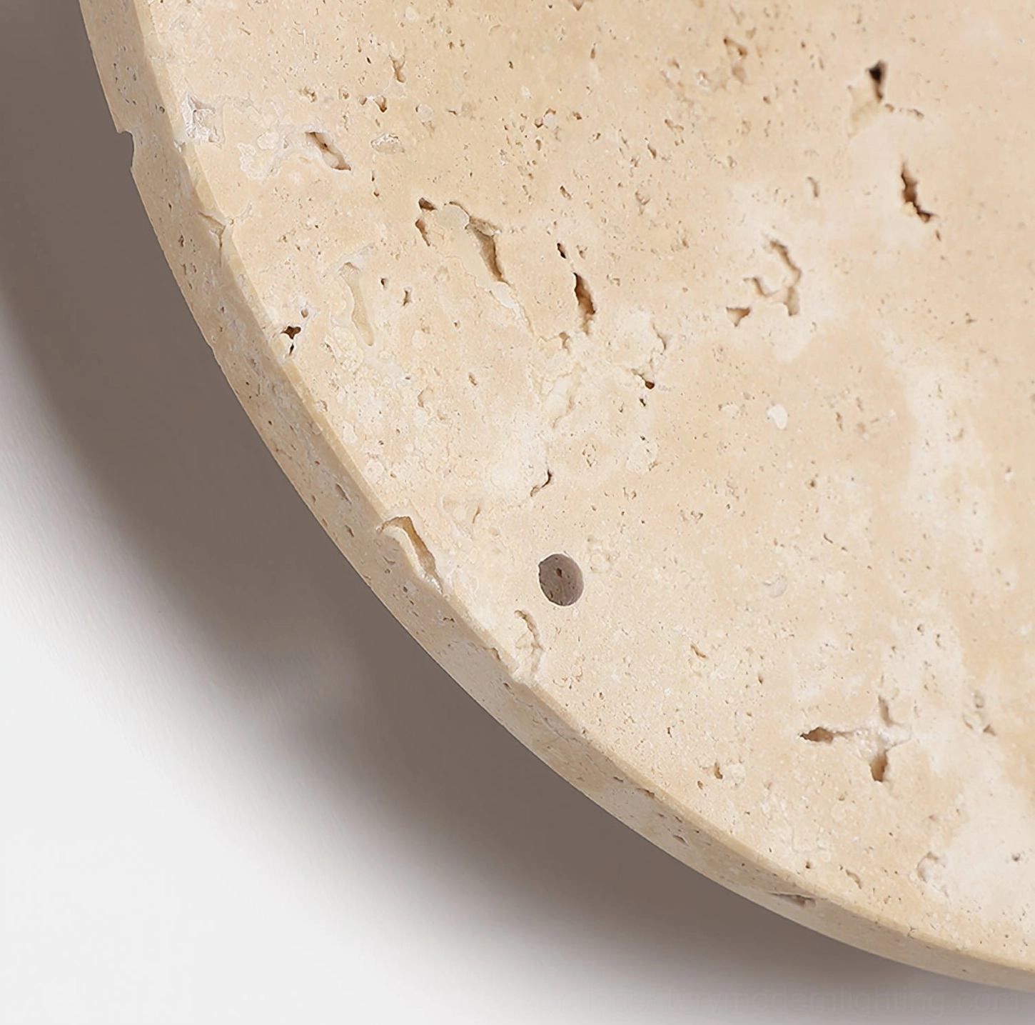 Travertine edge detail showcasing rough natural stone surface and authentic porous texture of lamp panel