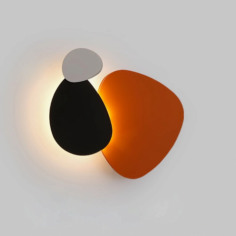 Tria LED wall lamp in grey, black, and burnt orange combination on minimalist white wall