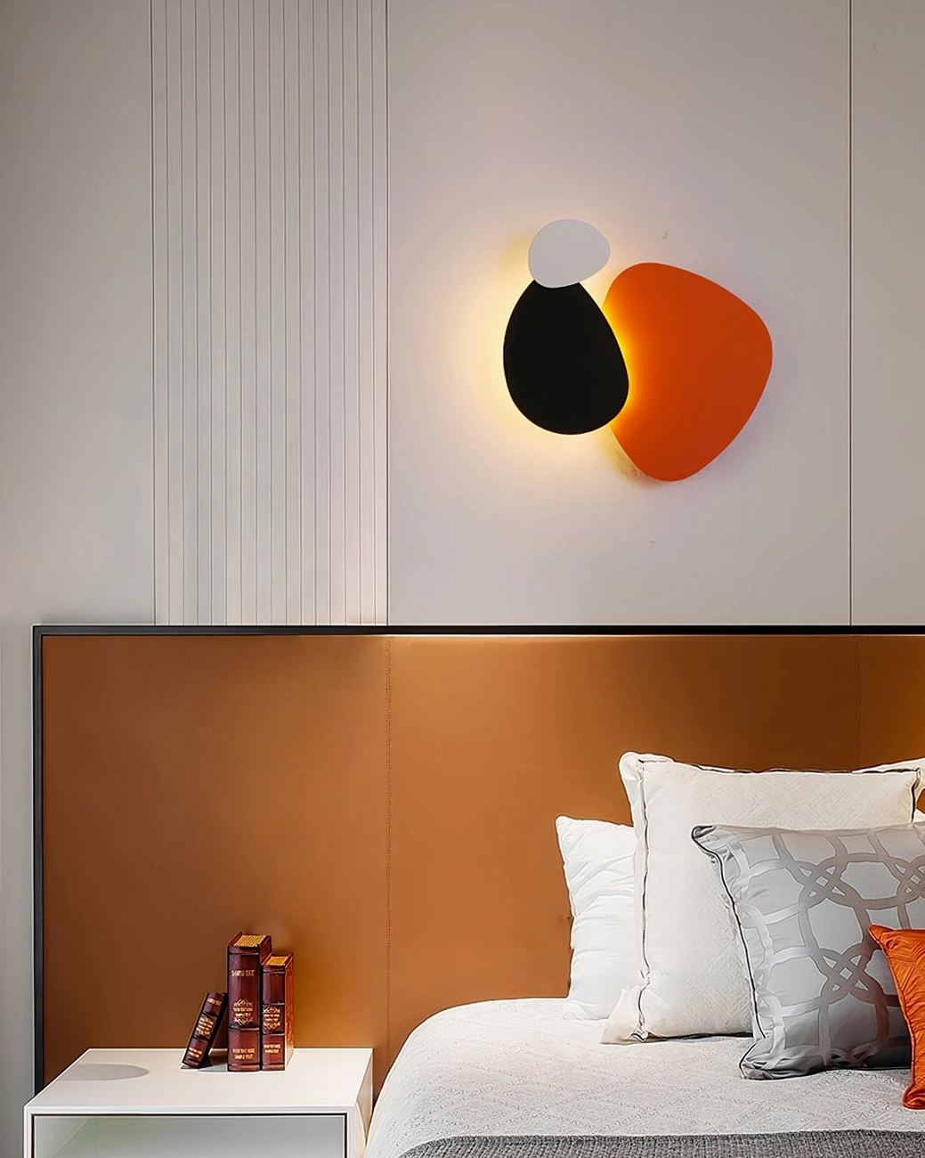 Tria geometric wall lamp demonstrating organic pebble-like form with mid-century modern inspiration