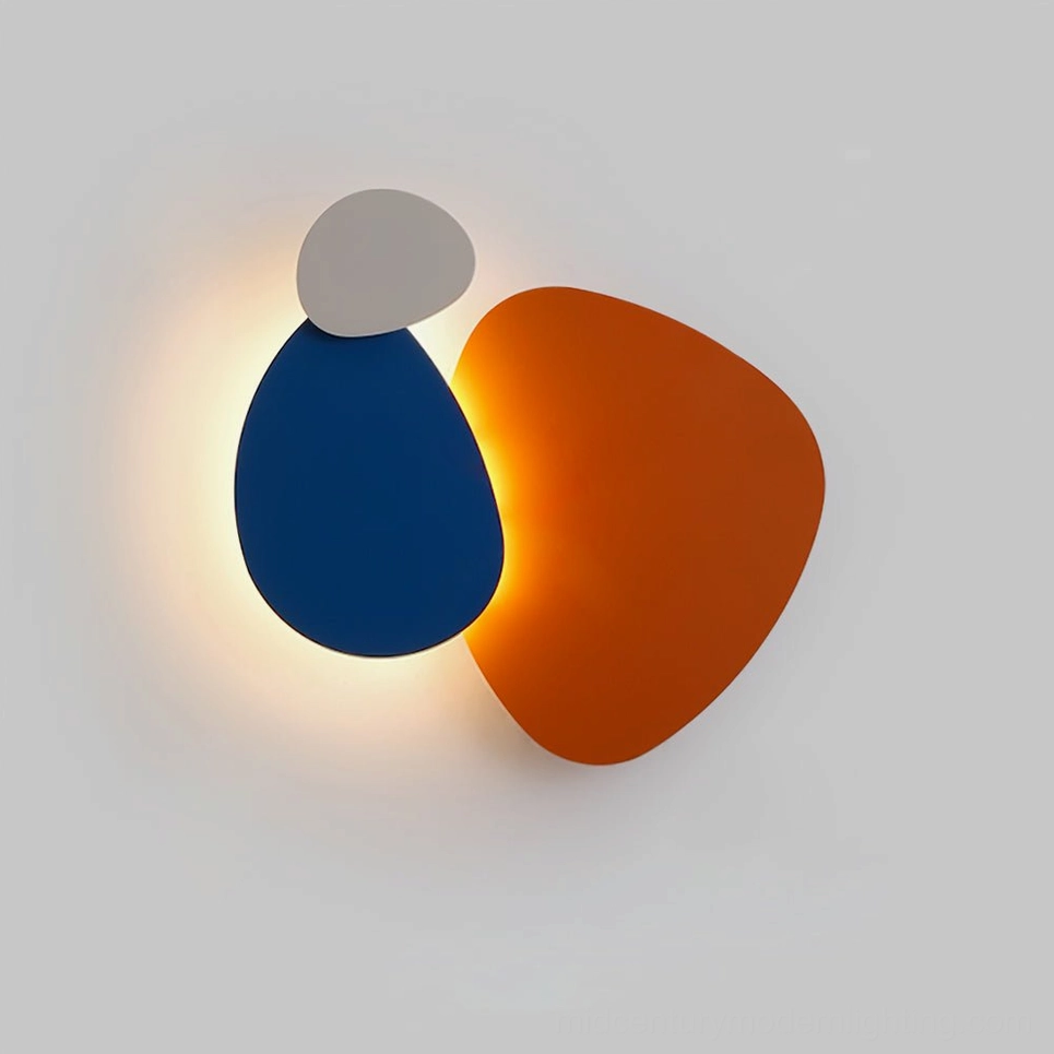 Tria wall light cluster in burnt orange and navy blue LED modules with backlit glow on white indoor wall