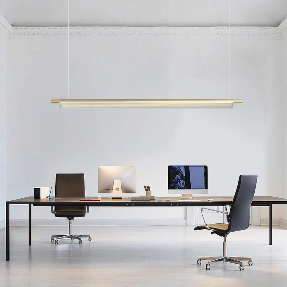 Trisel minimalist linear pendant light in gold finish, contemporary home office setting with clean aesthetic