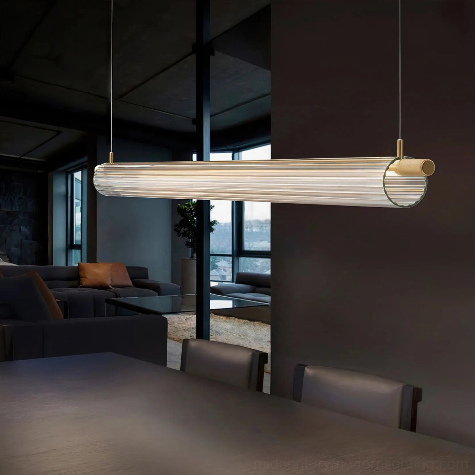 Trisel oversized linear LED pendant light with ribbed glass in dark-toned modern lounge, sophisticated commercial lighting design
