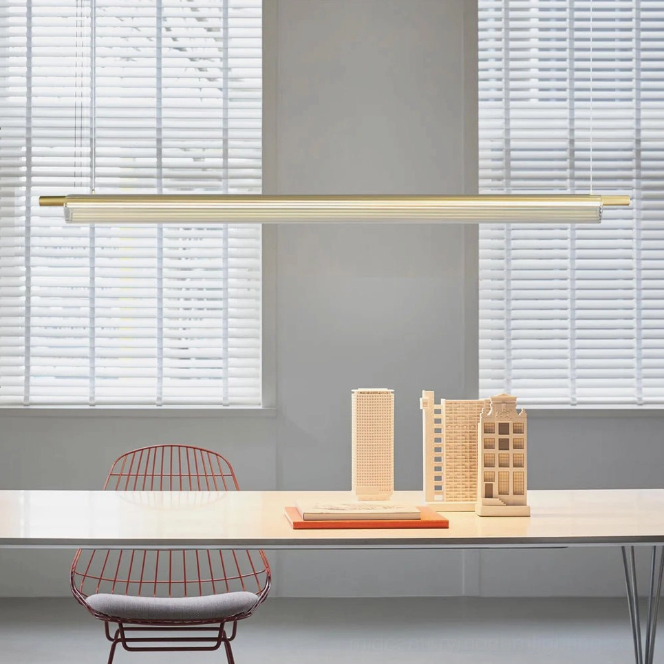 Trisel contemporary linear pendant light in modern workspace with louvered window blinds, minimalist office design
