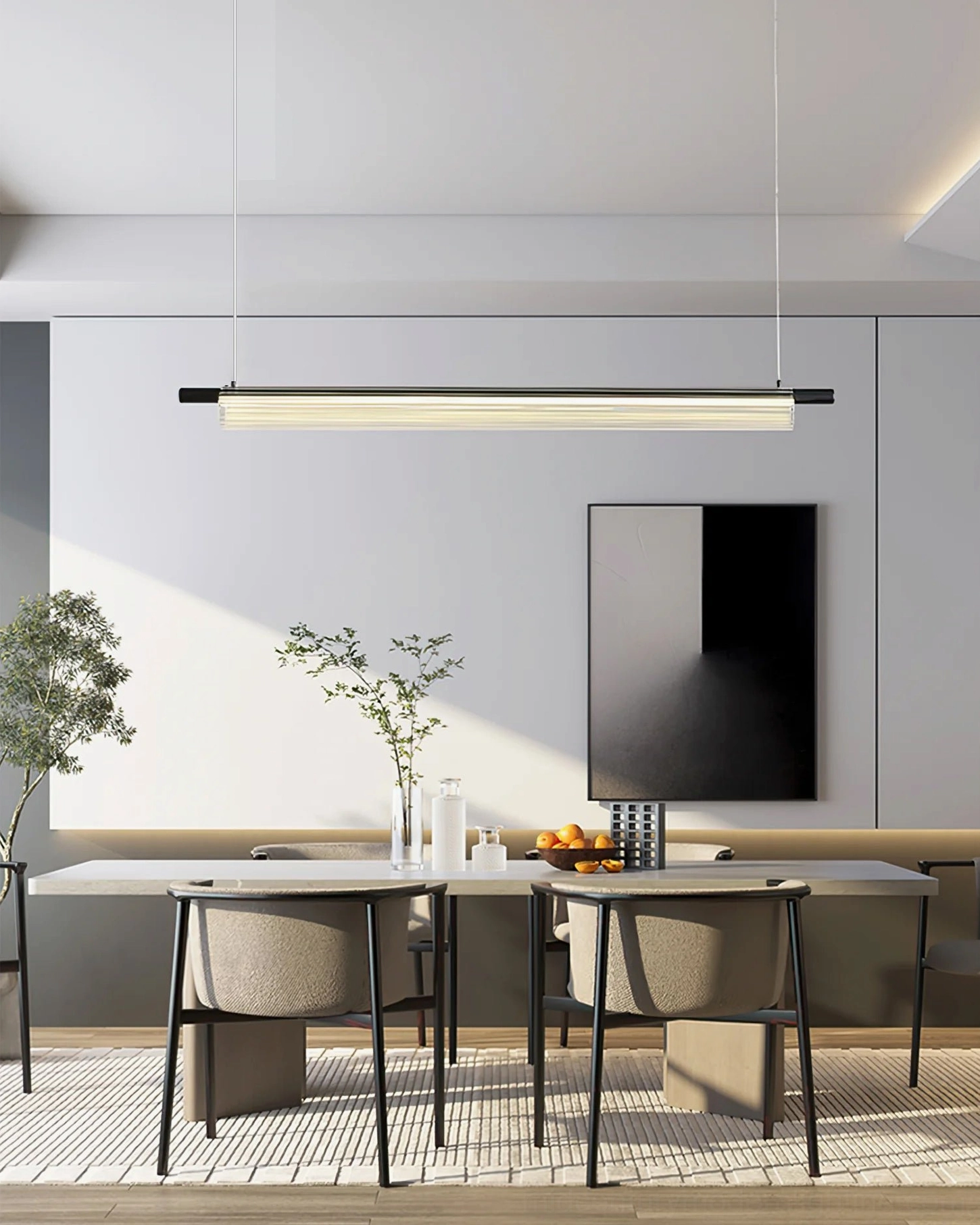 Trisel two-tone linear pendant light with brass and black finish in modern dining area, eye-level interior view with wall-mounted TV