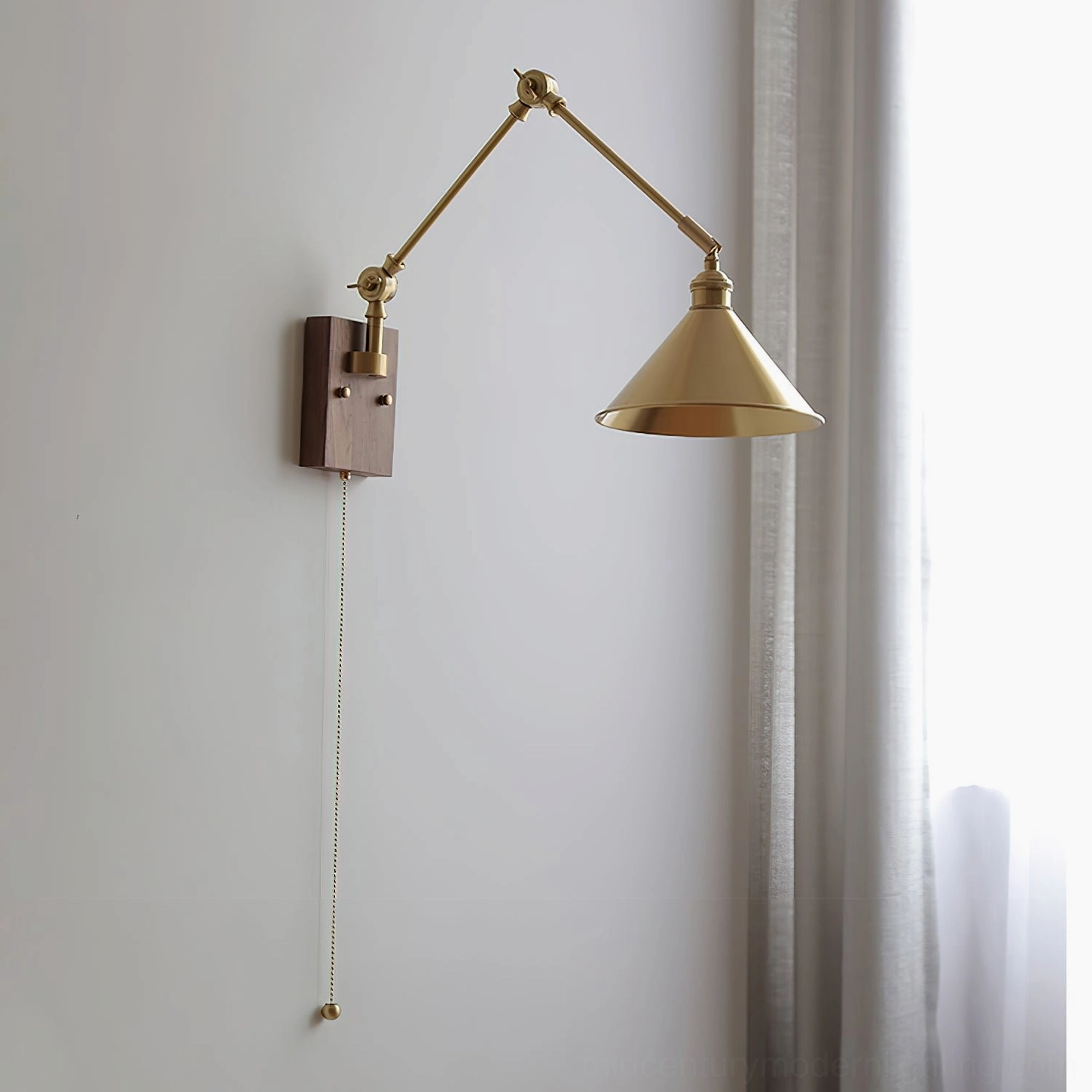 Troy Swing Arm Wall Lamp front view unlit conical brass shade with pull cord switch