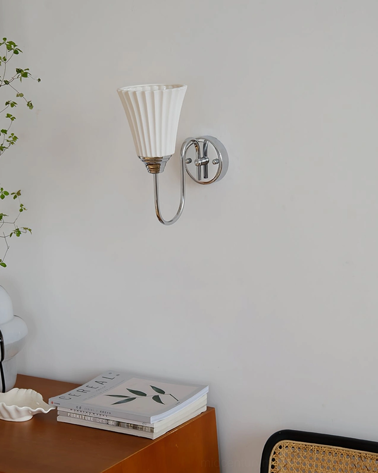 Brushed nickel ceramic wall sconce mounted on wooden side table corner - minimalist mid-century design