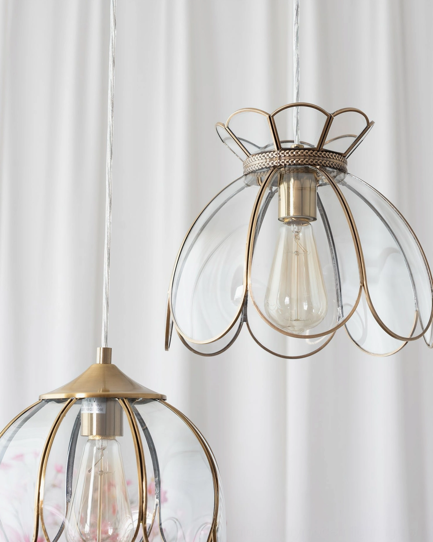 Turrella glass pendant light in various angles displaying petal shade form and brass finish