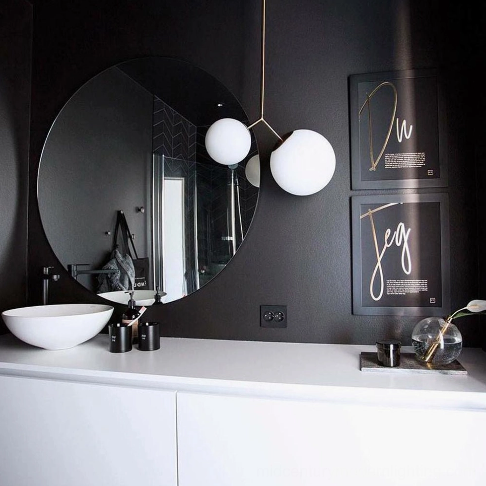 Twis black metal pendant light with frosted glass shades in modern bathroom powder room with dark accent wall