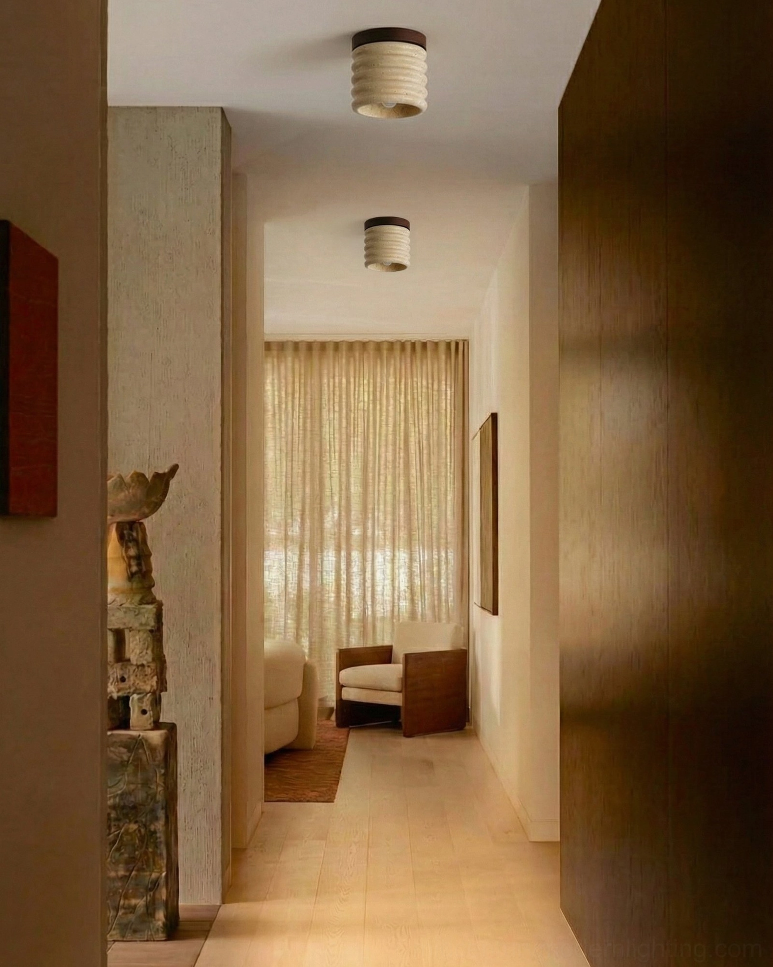 Dual travertine ceiling lamps in narrow residential hallway, understated warm neutral home design