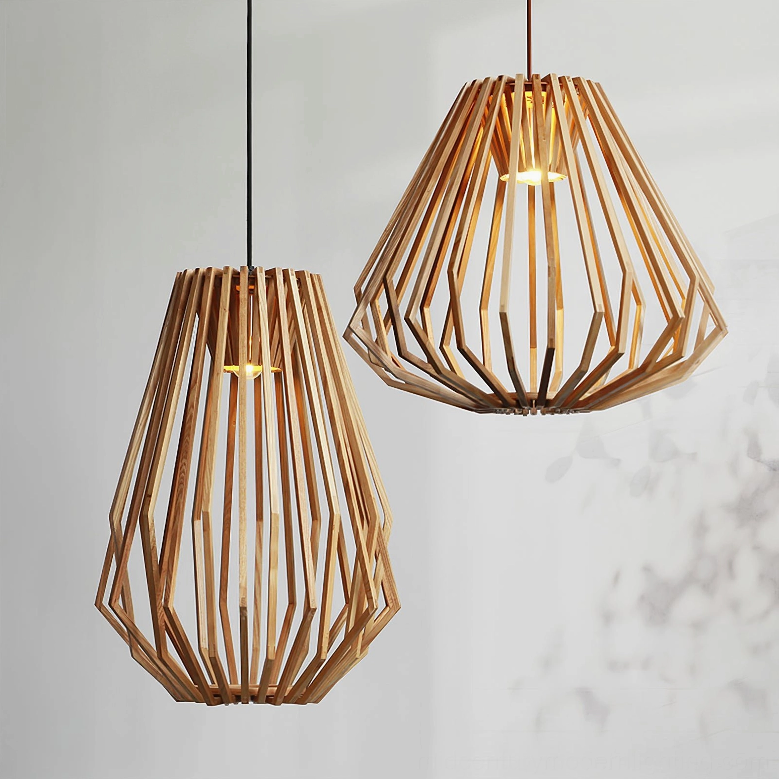 Pair of minimalist wood cage pendant lights showcasing tapered geometric design and natural wood grain