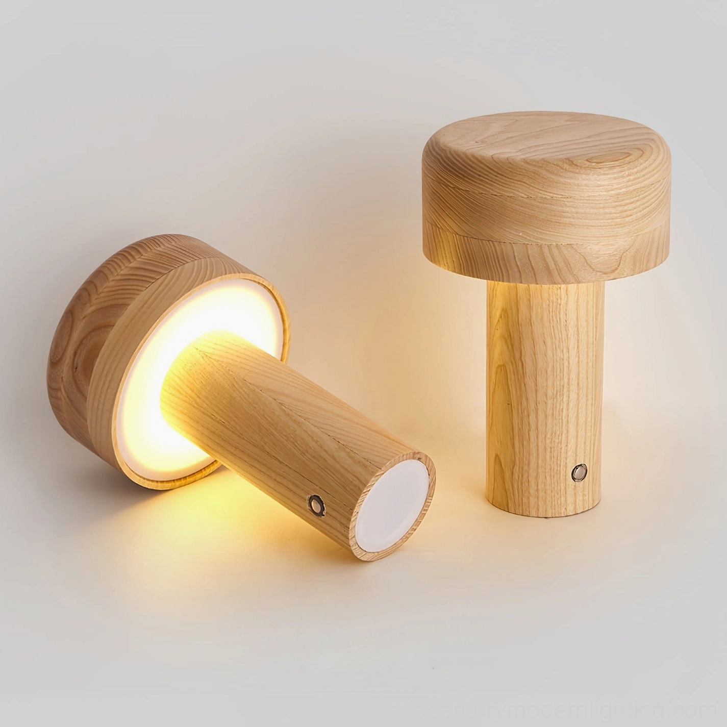 Pair of wooden mushroom lamps with touch switch visible on natural wood desktop, one illuminated