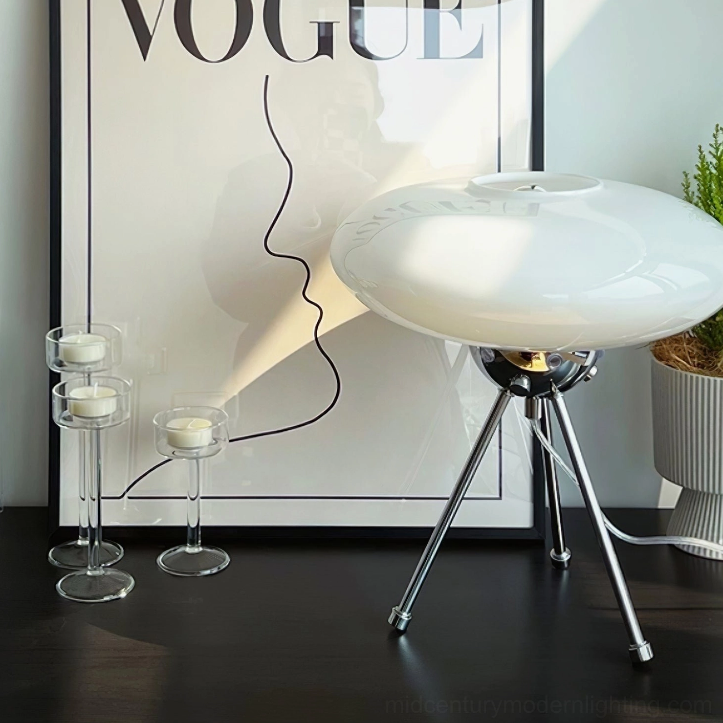 UFO table lamp side view with potted green plant, minimalist bedroom nightstand arrangement