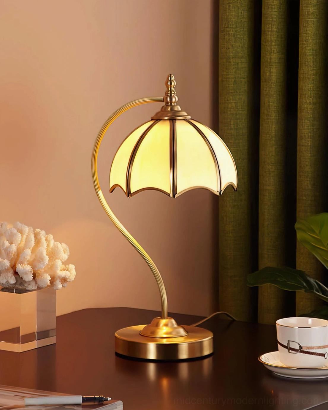 Umbrella lamp on wooden desk with coffee cup and stationery for home office styling